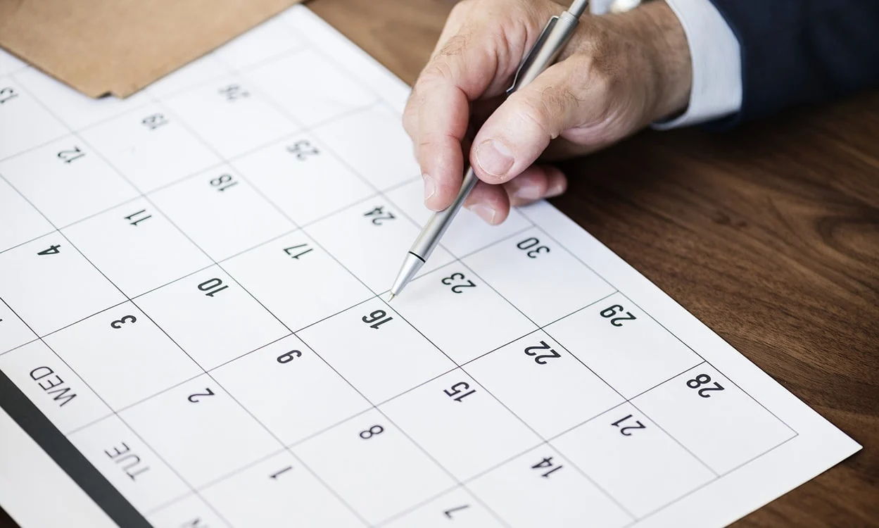 Businessman scheduling appointments in a calendar